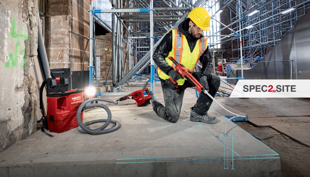 A worker injects epoxy anchor into a hole using a Hilti dispenser